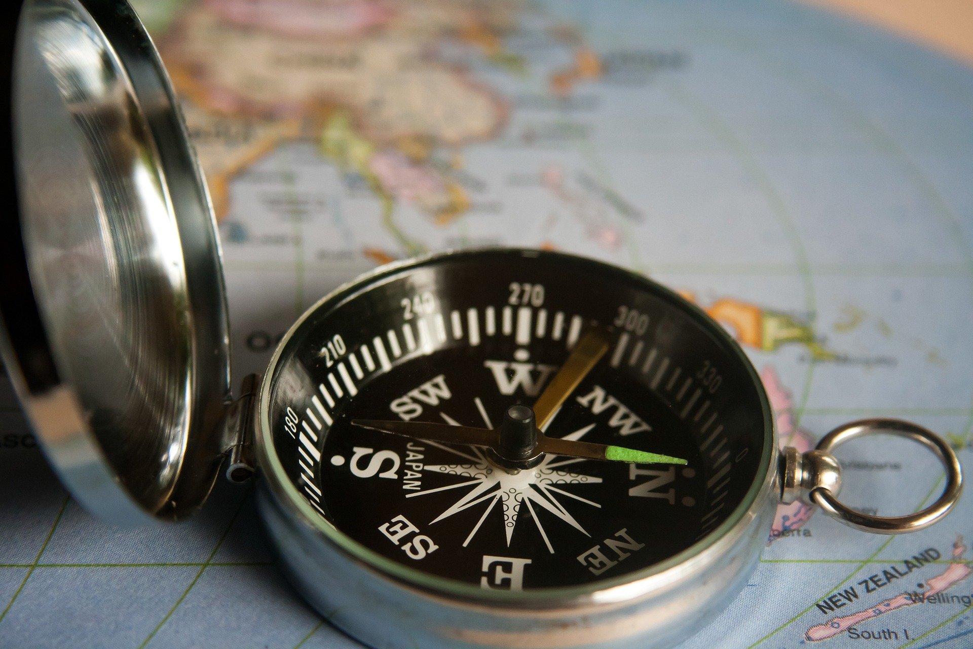 A classic compass resting on a map.