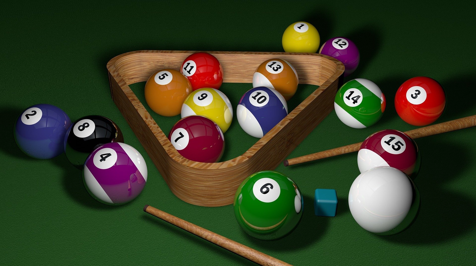 Billiards table set up with the balls and pool cue.