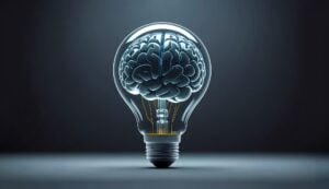 A brain inside of a light bulb showing both human mindset and AI.