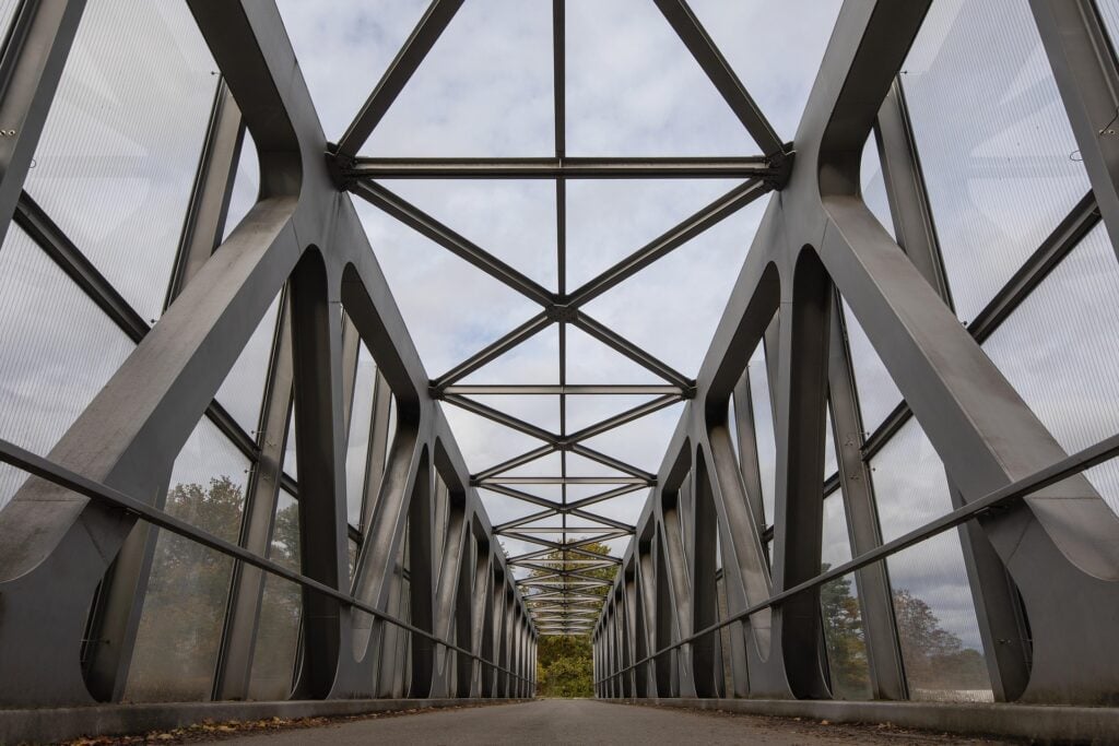 A very straight and architectural bridge moving down the center to horizon.