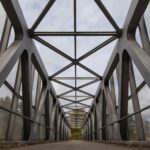 A very straight and architectural bridge moving down the center to horizon.