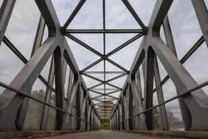 A very straight and architectural bridge moving down the center to horizon.