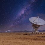 Large array radar dish on night sky background.