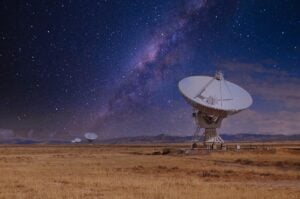 Large array radar dish on night sky background.