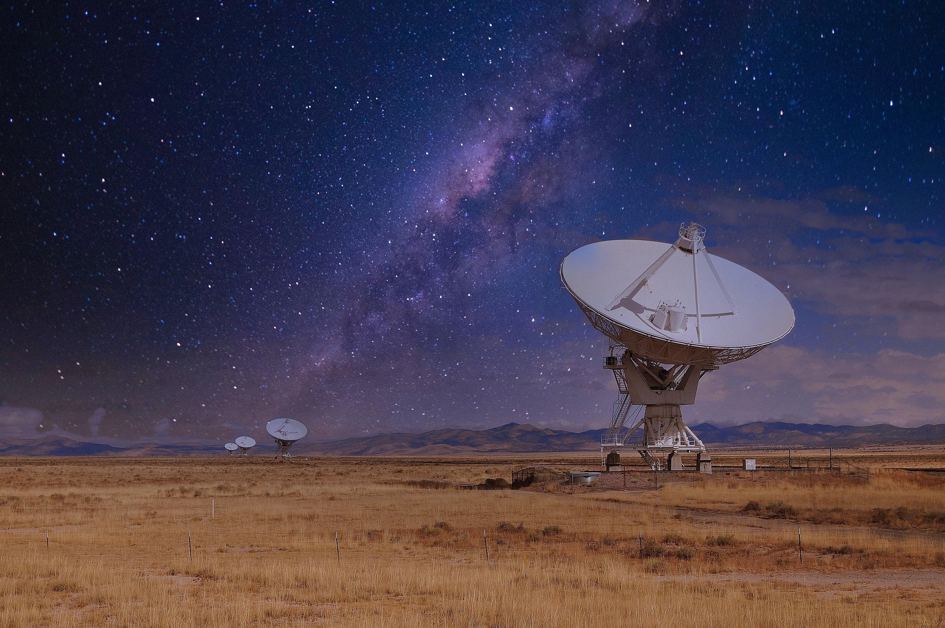 Large array radar dish on night sky background.
