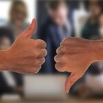 A thumbs up/ thumbs down in a business office setting.