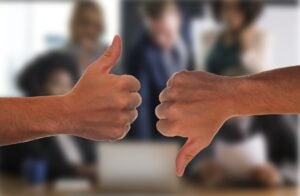A thumbs up/ thumbs down in a business office setting.