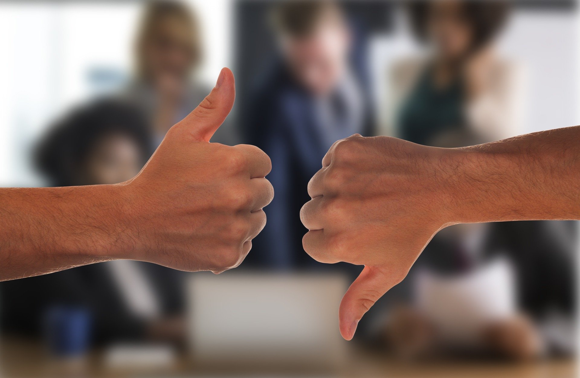 A thumbs up/ thumbs down in a business office setting.