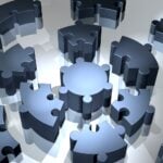 The loose pieces of a metallic, circular puzzle, radiating outwards.