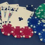 Playing cards showing royal flush, and with colorful poker chips.