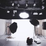 Behind the scenes of a multimedia studio, with background, lighting, camera.