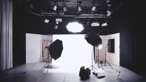 Behind the scenes of a multimedia studio, with background, lighting, camera.