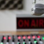 Radio or recording studio with on air sign, volume controls and microphone.