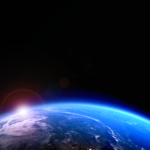 Sun rising and stars over the planet Earth.