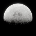 A shot of the moon looming up in space.