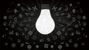 Graphic of a shining light bulb with all kinds of scientific, math and innovation symbols radiating all around it.