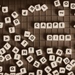 A jumble of block letters on a game board with Carpe Diem spelled out and standing out.